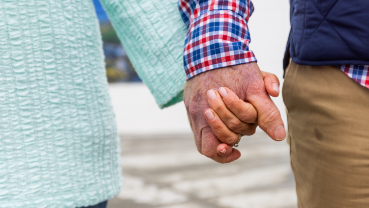 A couple holding hands who might benefit from joining an ATTR-CM advocacy group where they can get support from other patients