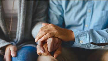 Couple holding hands to support each other through difficult times who may also benefit from advocacy groups where they can get support from other patients