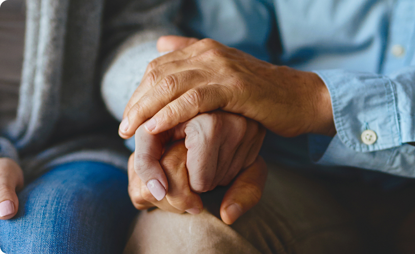 Couple holding hands to support each other through difficult times who may also benefit from advocacy groups where they can get support from other patients