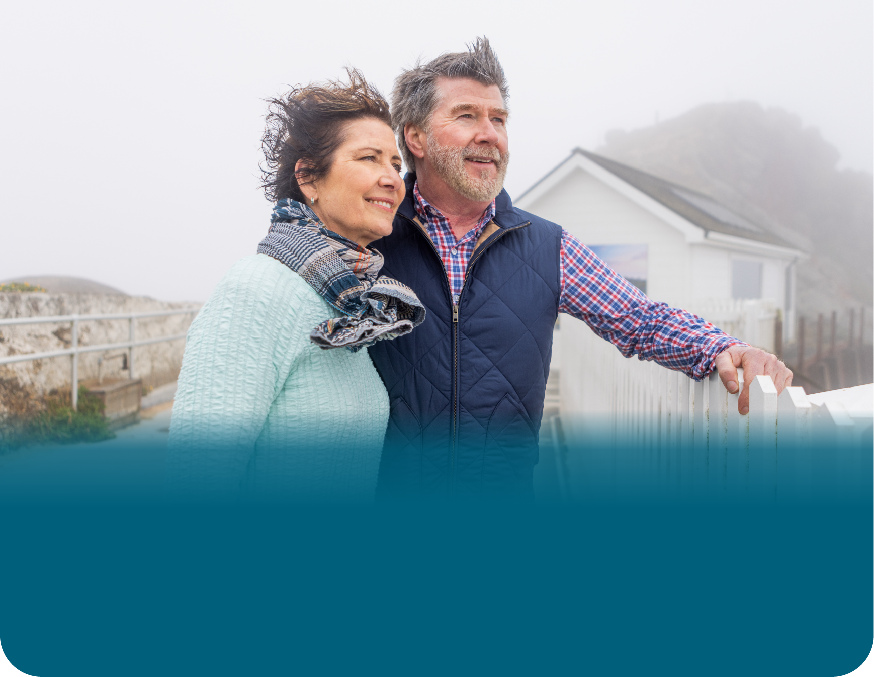 Actor portrayal of an older couple outdoors with wind in their hair