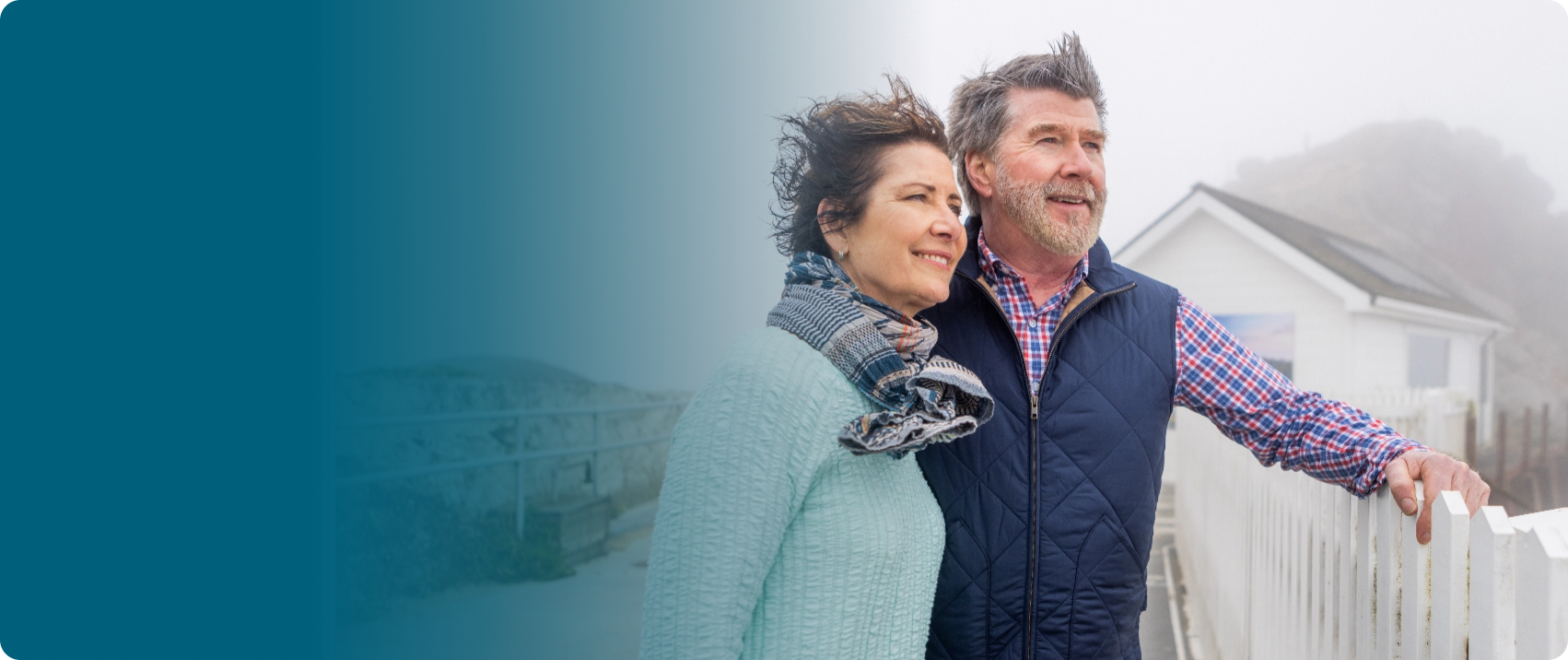 Actor portrayal of an older couple outdoors with wind in their hair