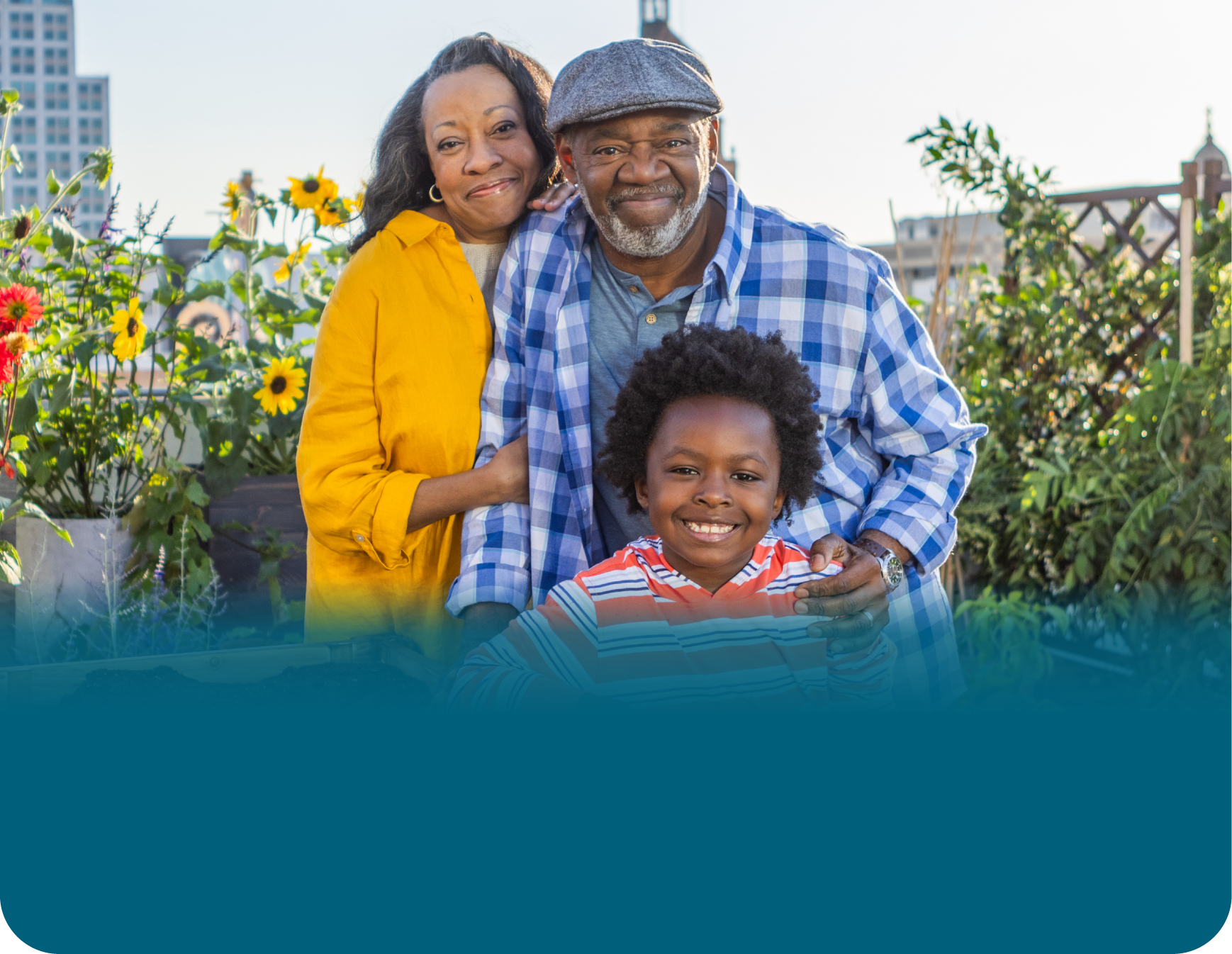 Actor portrayal of an older adult couple with their grandchild smiling at the camera